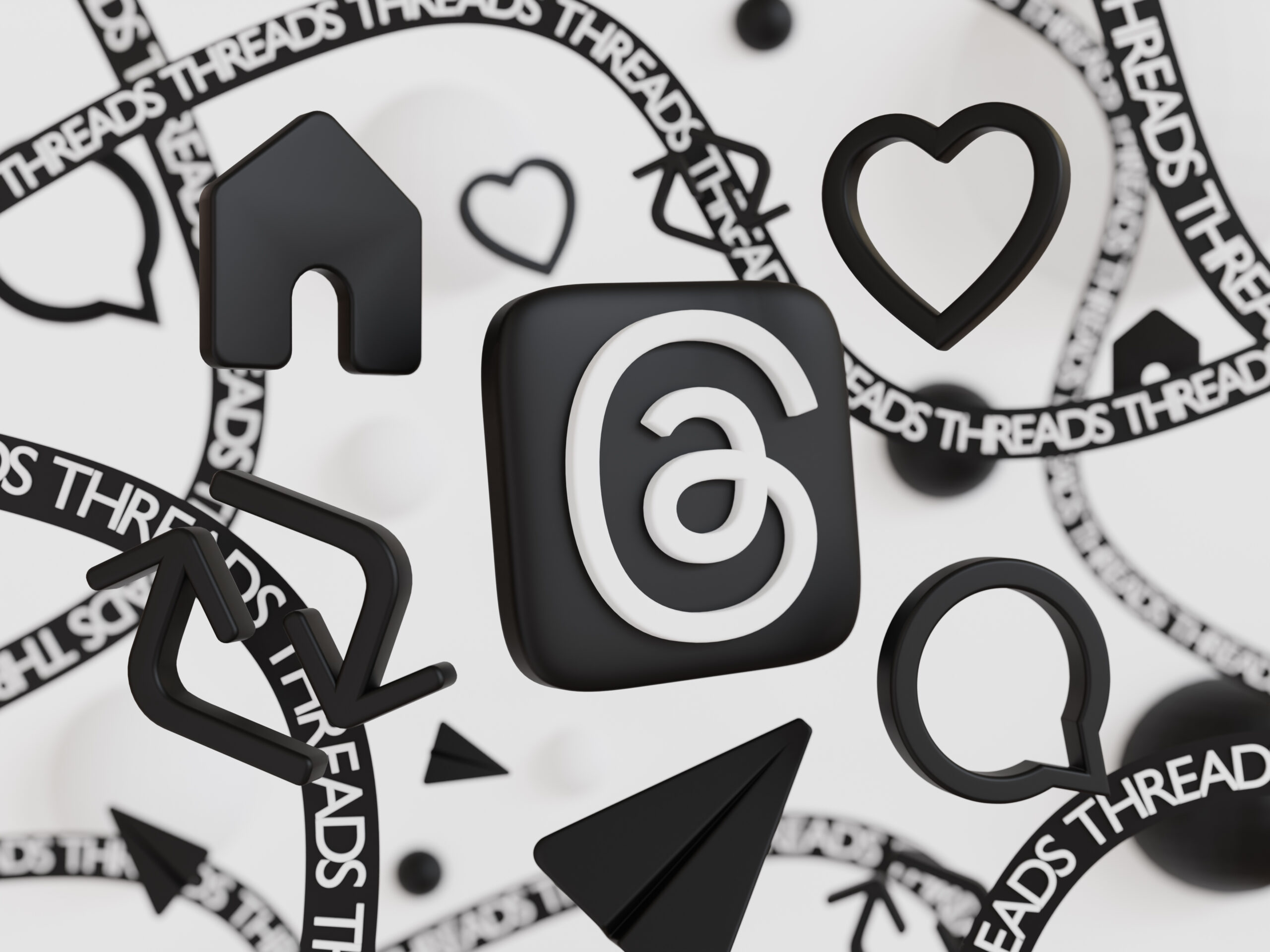 Image en noir et blanc avec le logo Threads de Meta, des likes et une icône de partage, des icônes de bulles de conversation et Threads écrit en plusieurs fois en forme de ficelles